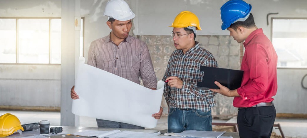 Builders And Architect Looking At Plans